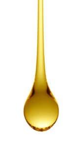 golden drop of oil on white background