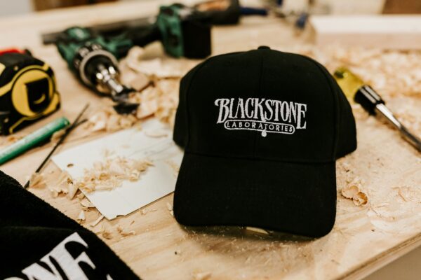 black adjustable hat with white blackstone logo