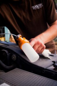 Image of someone holding a Blackstone oil sampling pump, getting ready to draw a sample from an engine