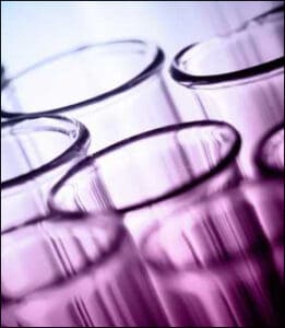 glass test tubes in purple light