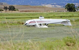 upside down airplane in a field