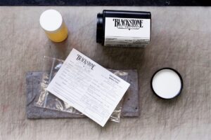 The contents one of our free test kits spread out across the work bench, being prepared for shipping. The oil has been collected and the paperwork has been filled out. Next step is to put it back in the shipping container and mail it back to us for testing.