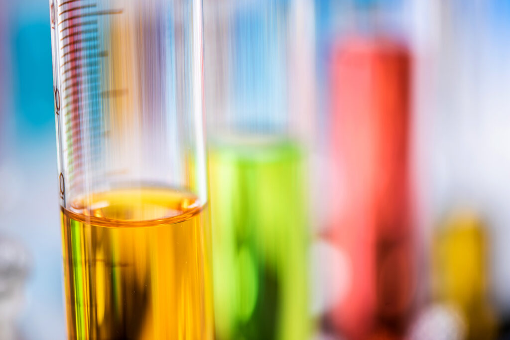 Cylinder Containing Chemical Liquid In Laboratory, Lab Chemical Research And Development Concept Oil, coolant, and fuel samples in test tubes for analysis