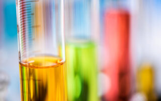 Oil, coolant, and fuel samples in test tubes for analysis