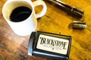 An oil sample kit on a workbench next to a cup of coffee