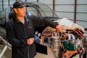 Ryan demonstrating a compression test on the Rotax engine in his RV-12