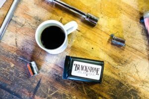 Blackstone kit on a workbench with a cop of coffee, socket wrench, and a few sockets