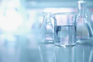 Three glass beakers on a blue background