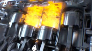 A cutway of an internal combustion engine showing combustion taking place in two cylinders.