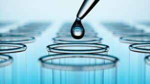 Drop of liquid about to be dropped into a glass test tube