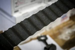 Very dark oil filter pleats spread out with speckles of glittery metal strewn about the pleats.