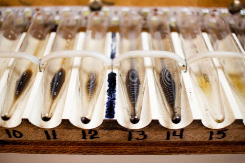 test tubes containing used engine oil, set up in a rack so one of our lab technicians can measure the level of solids in the bottom of the tube.