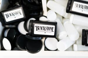 Black kit mailers that say Blackstone on a nest of white bottles and black lids