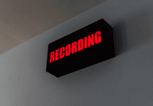 Black sign with "Recording" lit up in red