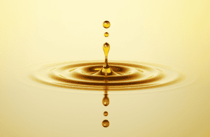 Oil drops splashing in a pool of oil