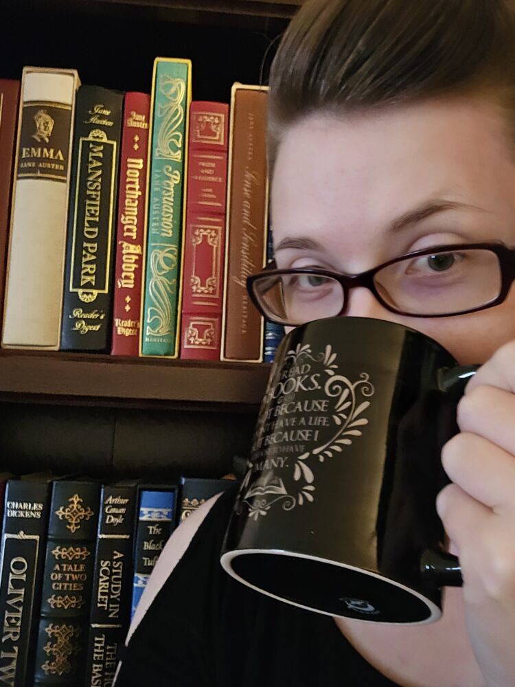 Deborah holding a coffee cup