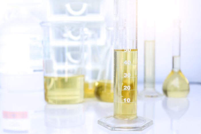 Glass cylinders and flasks containing oil