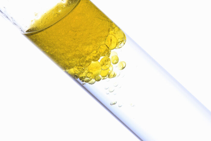 test tube with a clear separation between the oil and water contamination