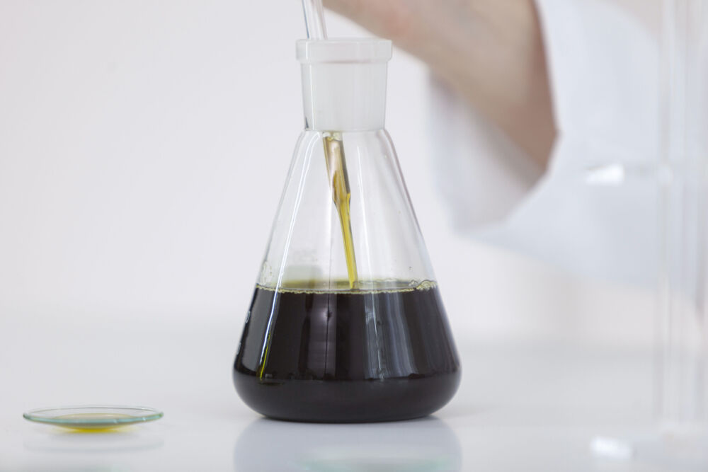 Dark oil in a glass flask