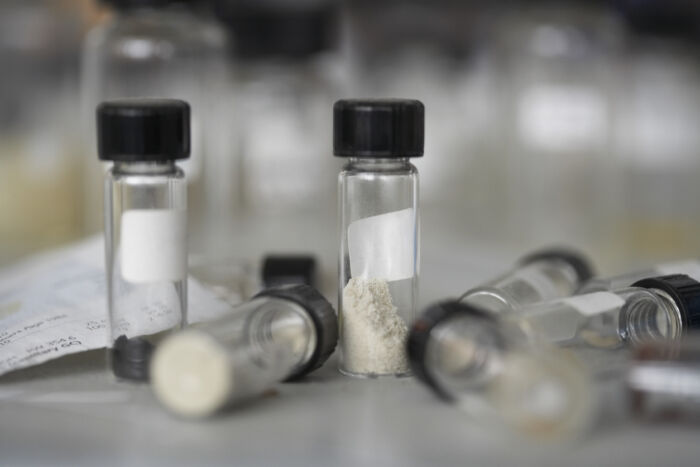 Small test tubes with ash in them, some lying on their sides