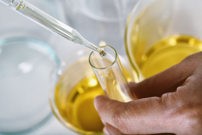 Oil dropping into a glass test tube
